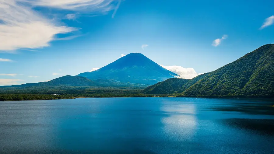 Download a special laptop background image and a beautiful view of the calm blue sea and the two-colored mountains with the sky