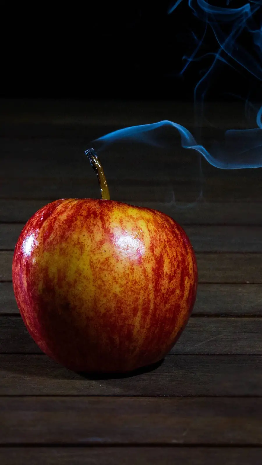 Apple with smoke rising from the bottom in the shape of the Apple logo
