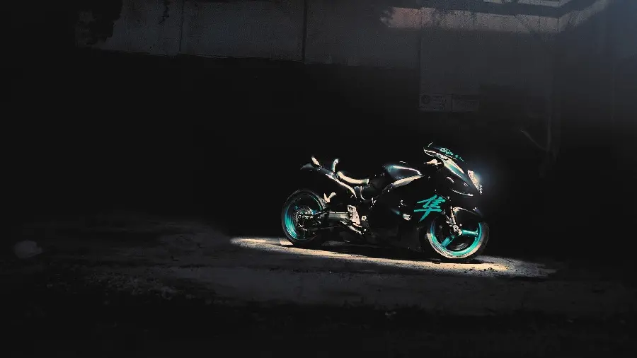 Download a compact photo with some light of a black and slightly green motorcycle in hd quality