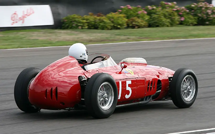 Awesome background photo of an old and classic Ferrari car with a driver in a high-quality rally