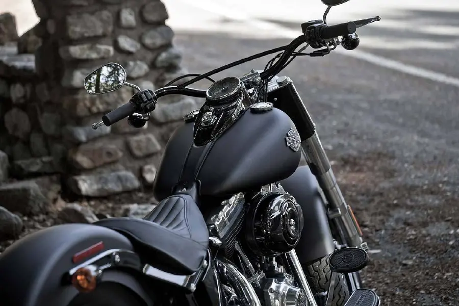 Magical image of shiny black motorcycle next to brick wall