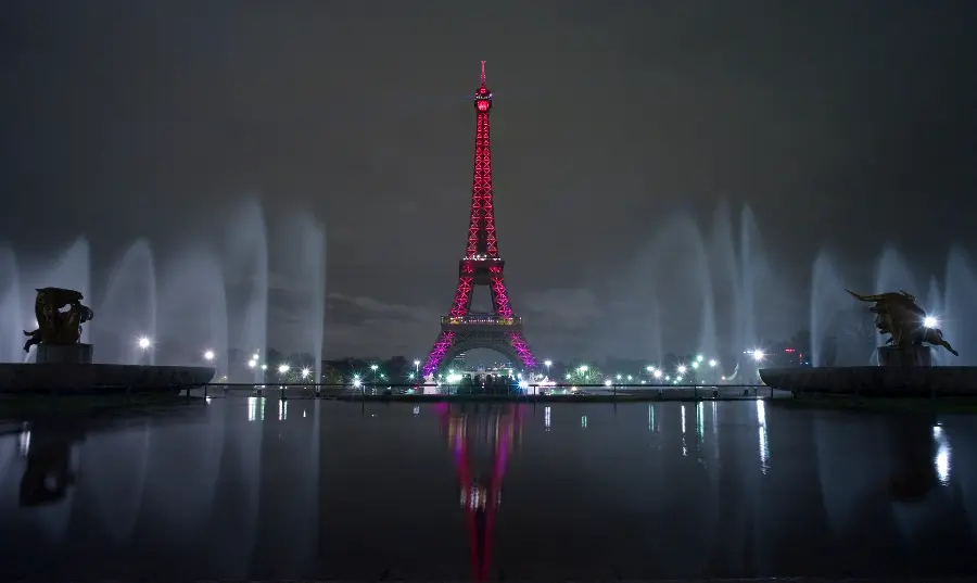 Download a cute vector of the pink Eiffel Tower and the roaring fountains next to it at night from the city of Paris, a symbol of French culture