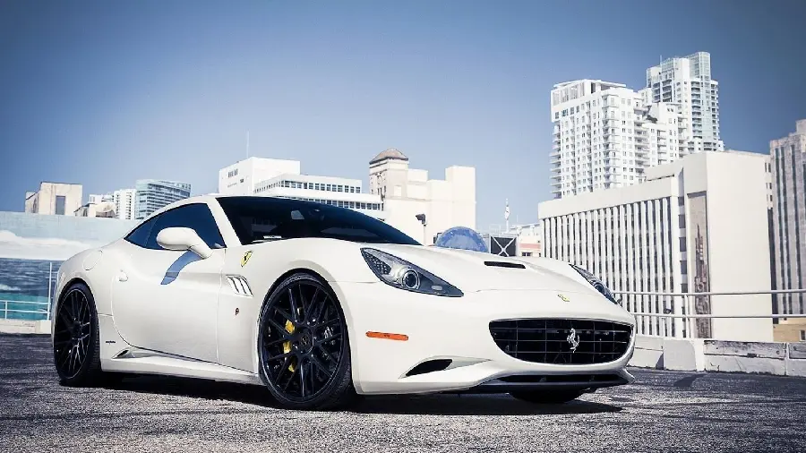 Attractive profile photo of a white Ferrari next to tall towers in full quality