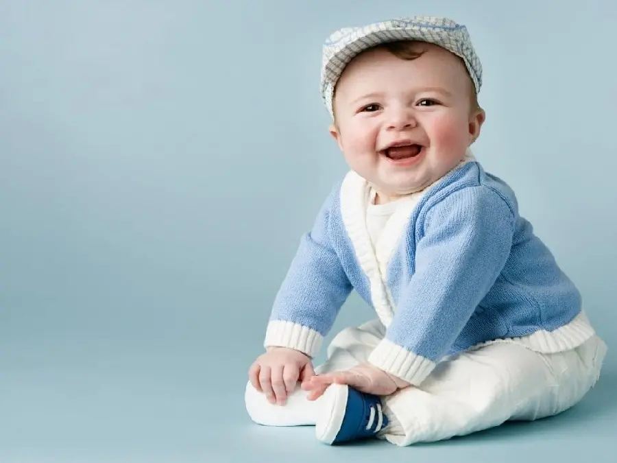 Special photo of a funny foreign boy in a blue and white dress