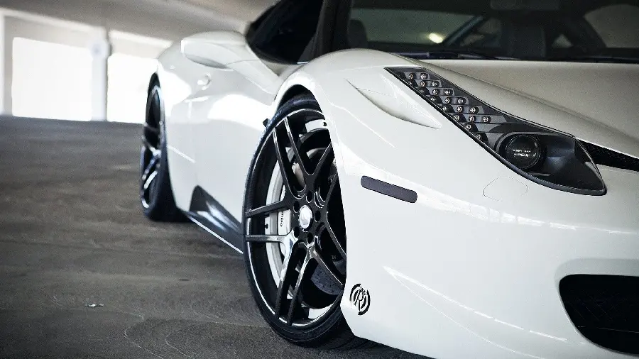 Download a unique background image of creativity in the design of headlights and tires and rims of a white Ferrari