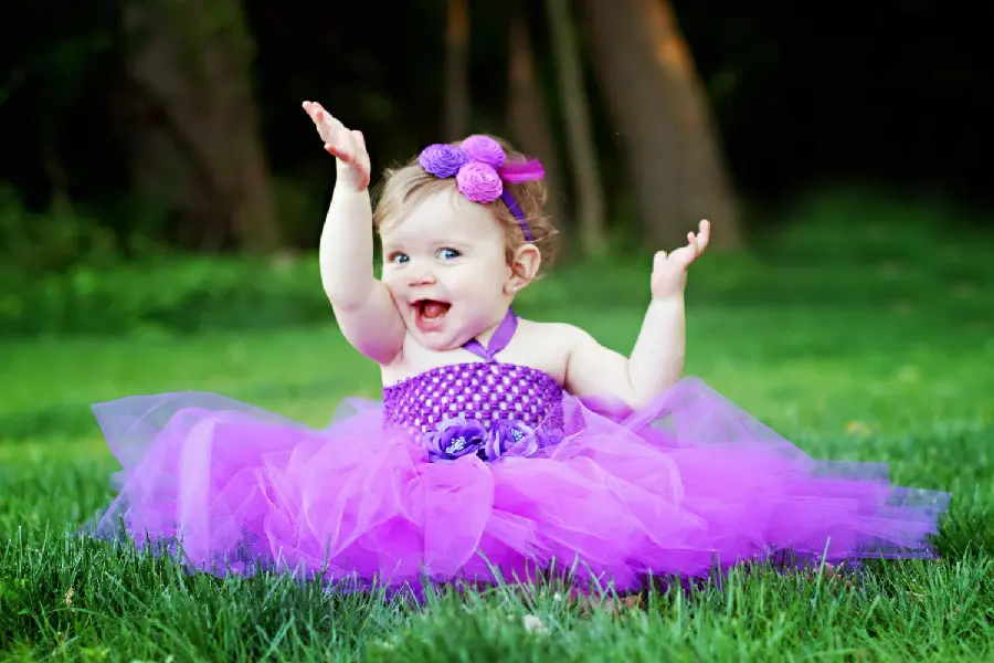 Popular wallpaper and photo of a cheerful and naughty little girl in a purple dress