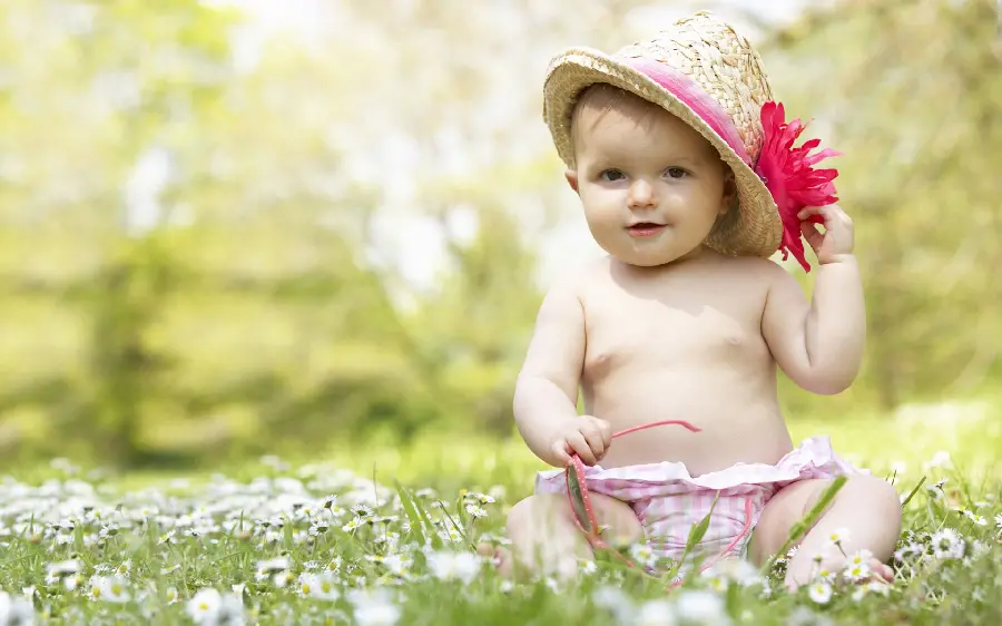 New and pleasant background and photo of a cute little girl in lush nature for desktop 