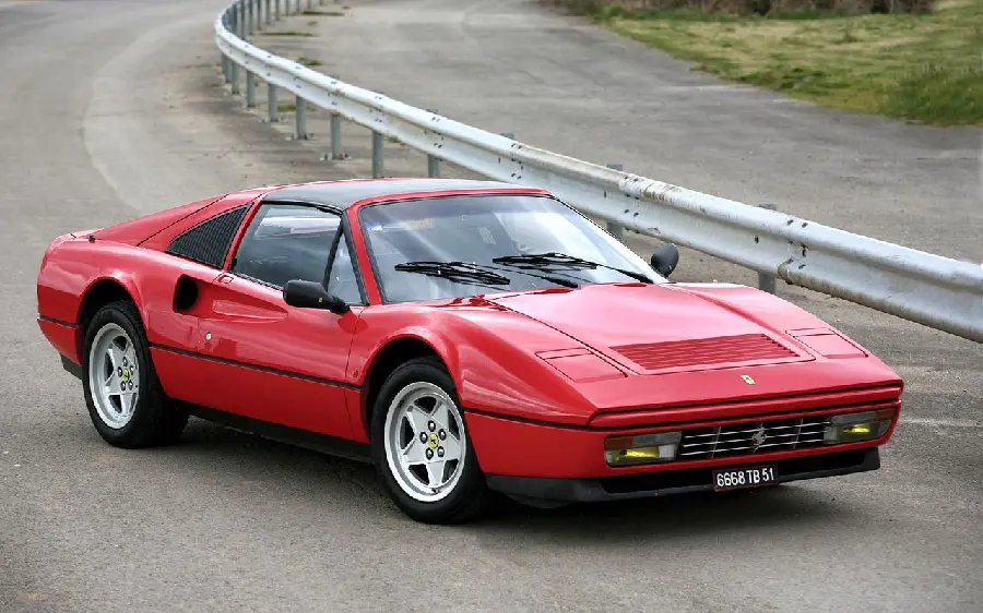 A cool stock image of a classic old red Ferrari on the road with a special headlight option