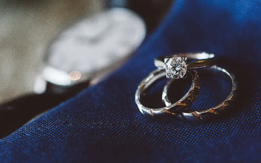 Download the magical wallpaper of three diamond rings next to a watch