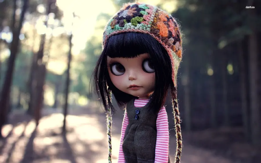 Beautiful view of a little girl doll with big black eyes 