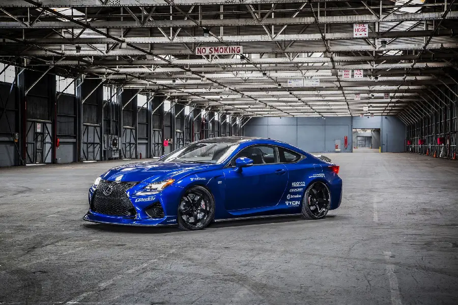 Shiny profile photo of blue Lexus RC F in the parking lot of the race