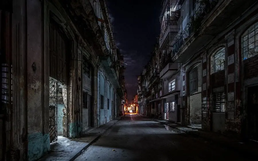 A dark and unsightly background of a city road next to dilapidated houses