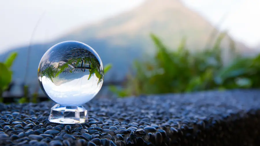 A dreamy wallpaper of a transparent glass ball in the heart of nature