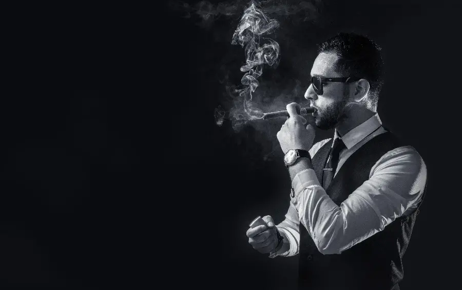 Luxurious stock photo of a gentleman with glasses smoking a cigarette