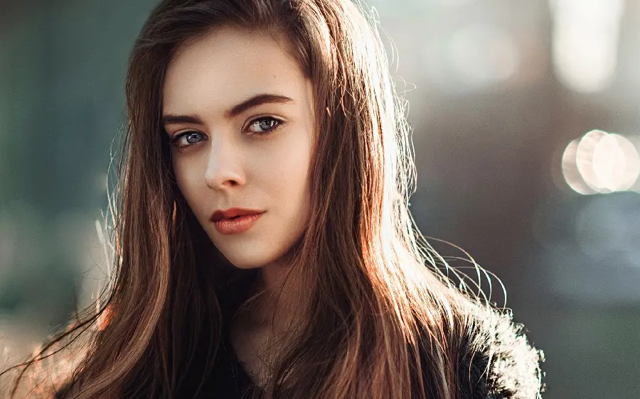 A very beautiful background image of a natural girl with hair and a mysterious look in full quality