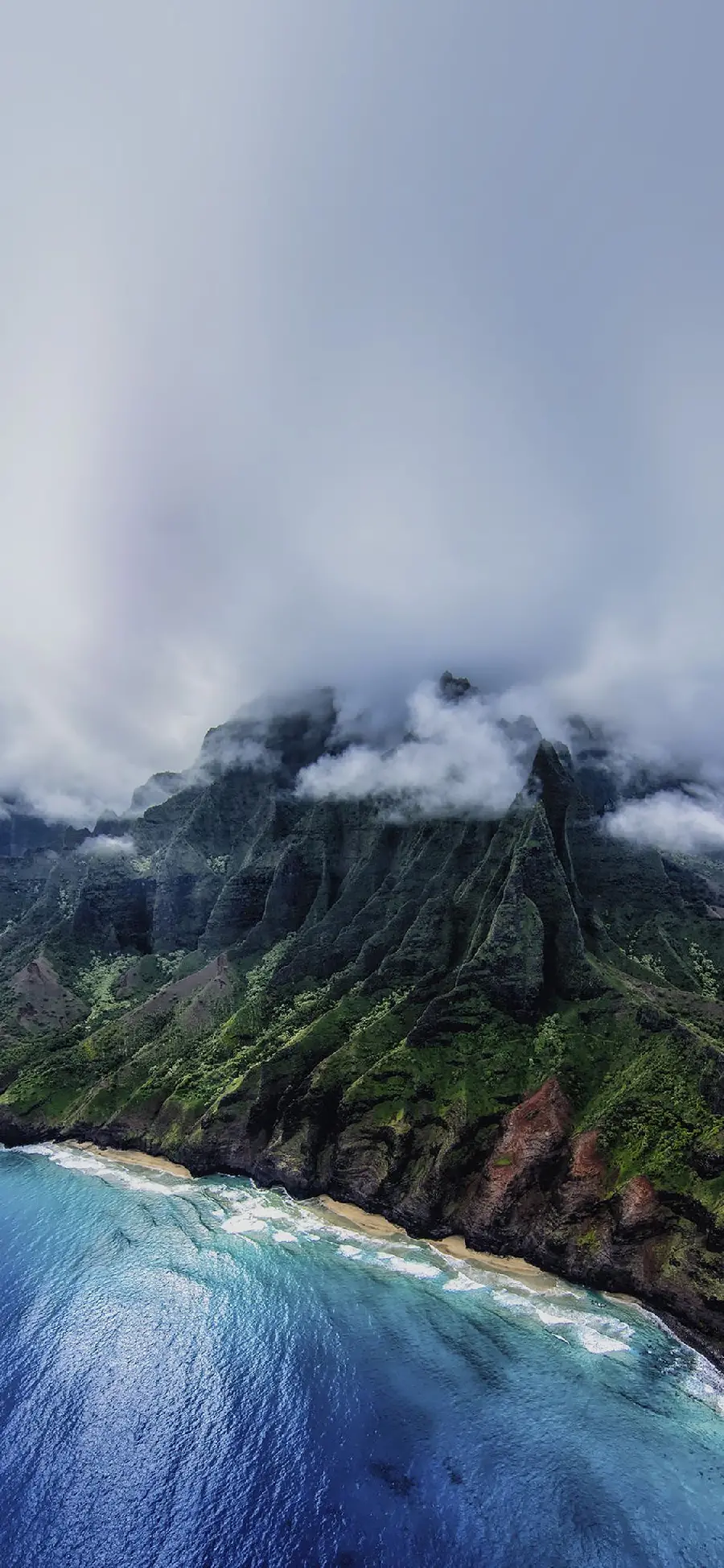 Download the creative and new poster of the ocean and the mountains covered with green plants And immersed in the cotton clouds