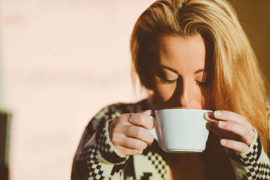 Beautiful view of a golden-haired girl drinking for a telegram profile