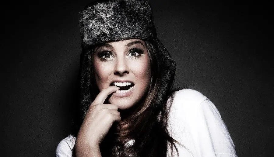 Special WhatsApp profile photo of a cheerful and naughty girl with beautiful eyes and hair and a black hat
