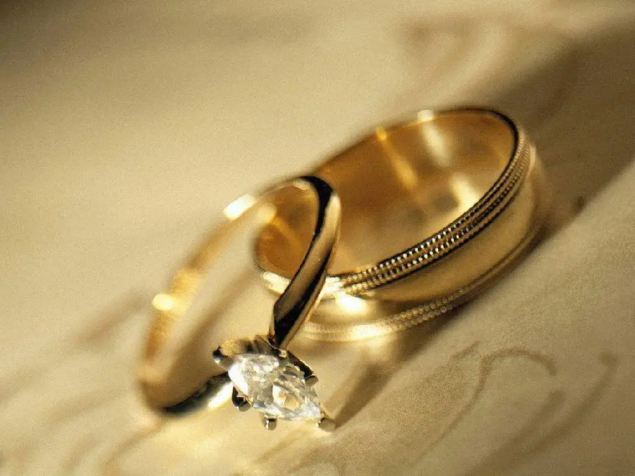 Download Stock Image Two Gold Wedding Rings One With Diamond