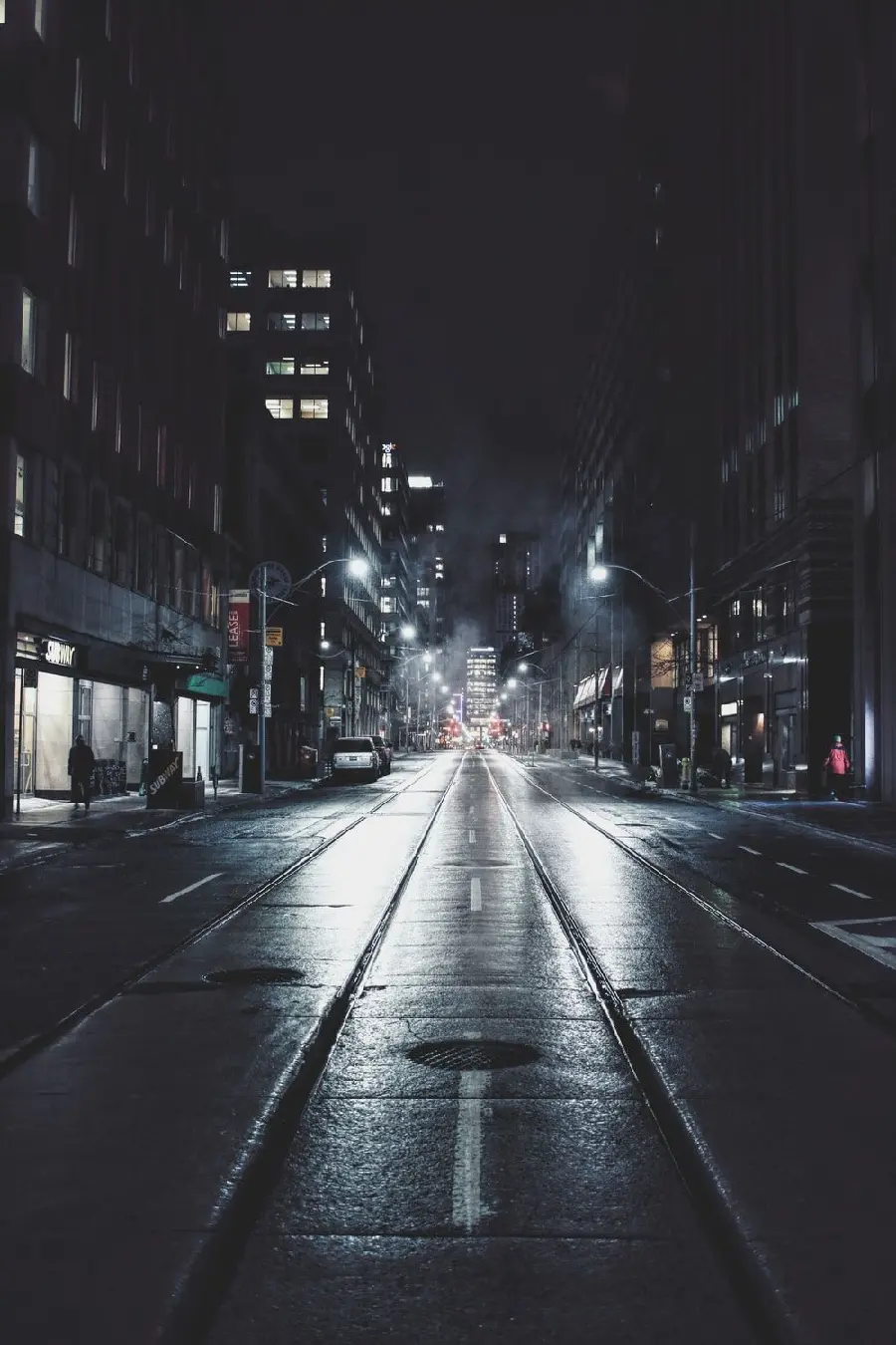 Shiny and bright stock photo of a black city road at night