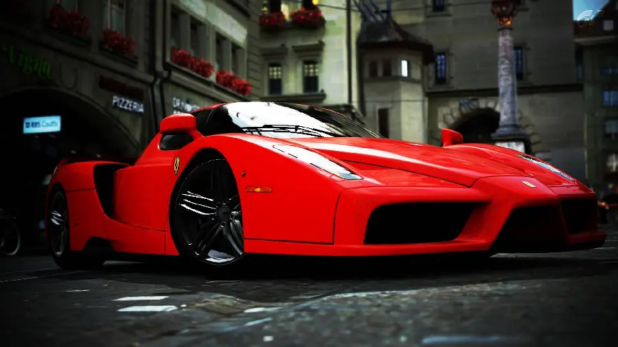 High quality photo of Ferrari Enzo in a diagonal position next to houses