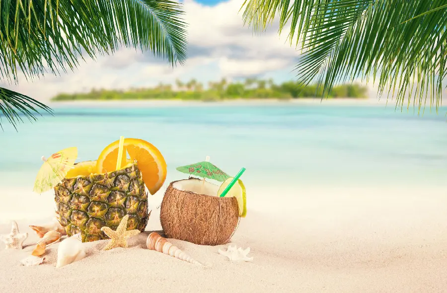 A dreamy stock image of a coconut and pineapple drink near the seashore in full HD quality