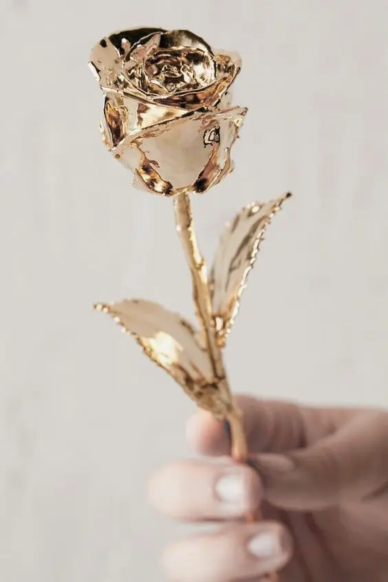 Blurred and unknown poster of golden flower in fingers