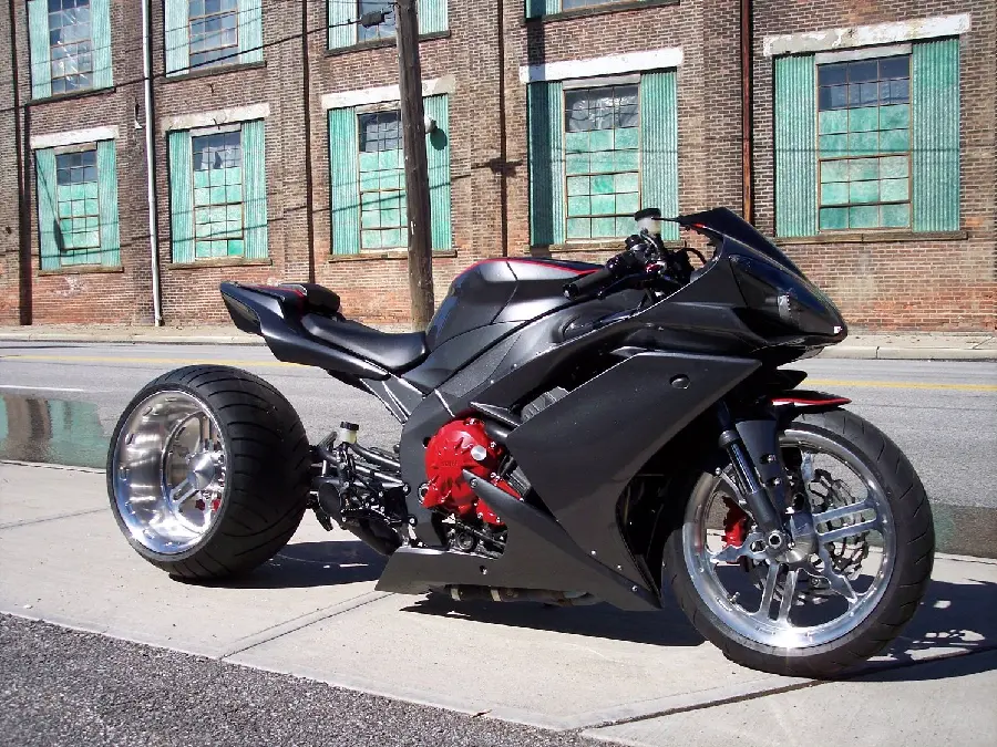 Download image of a black sports motorcycle next to many windows in HD quality
