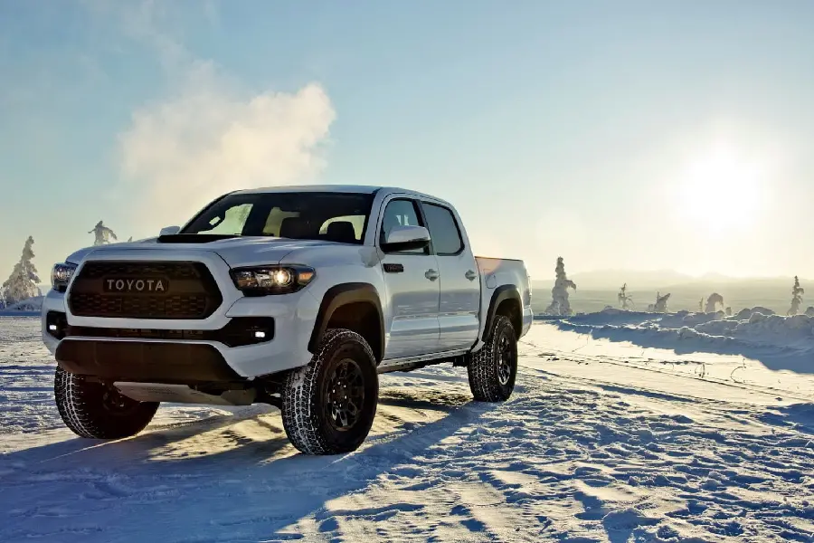 A spectacular photo of a white Toyota Tacoma in snowy weather in HD quality suitable for Windows