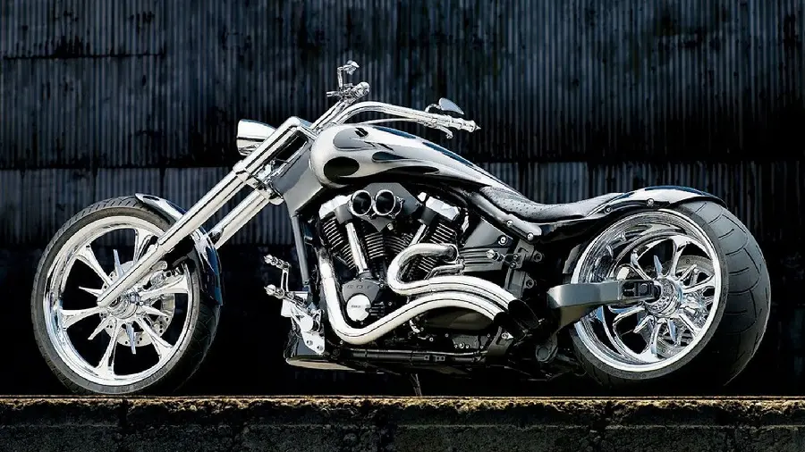 Download a photo of a shiny silver new and heavy custom motorcycle with a matchbox background