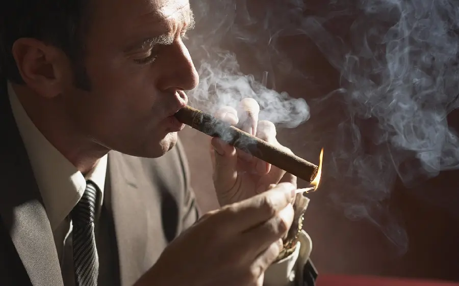 Attractive and imposing man smoking a cigarette in a special and artistic view 