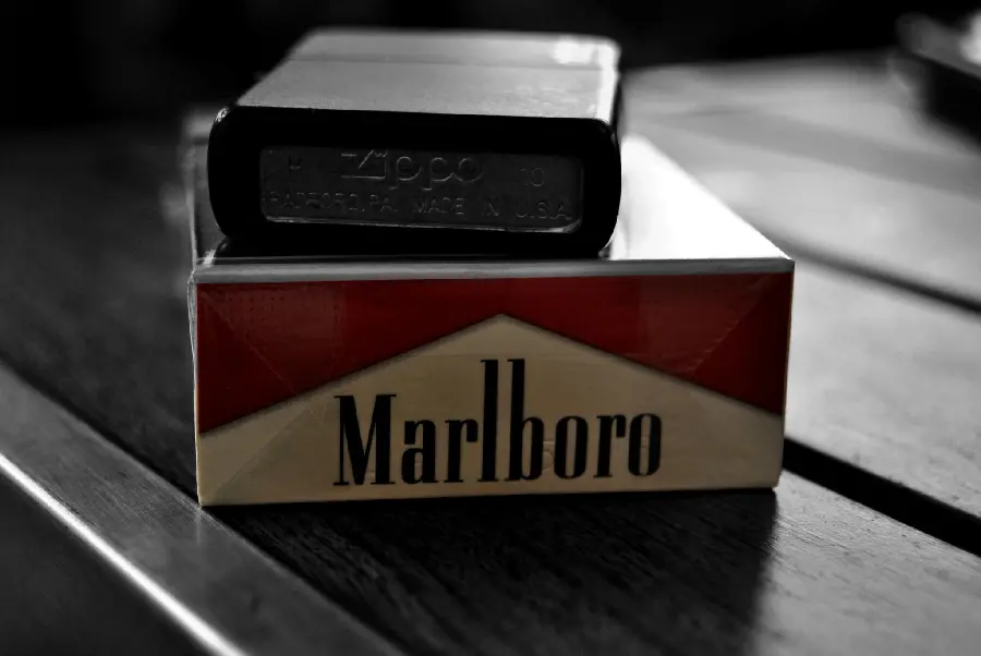 Marlboro cigarette with lighter on it as background
