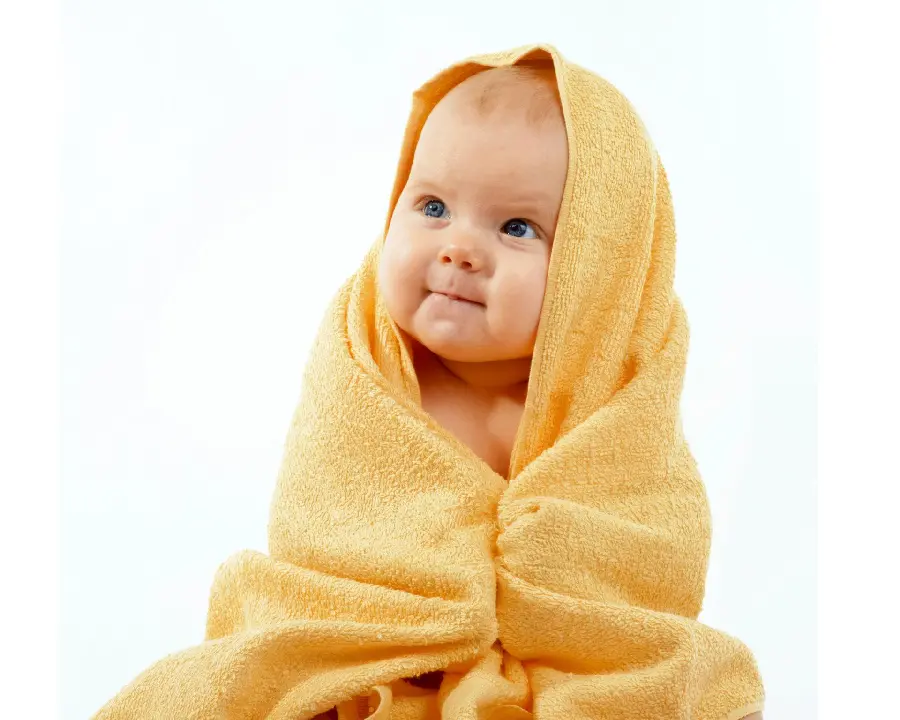 The cutest wallpaper of a cute and chubby little baby in a yellow blanket in Full HD quality 