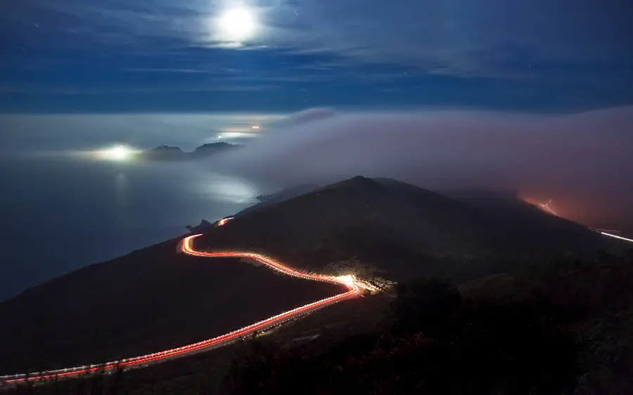 A strange photo of nature immersed in silence and a landscape photo of a lighted road in the mountains