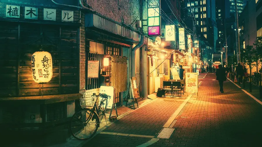 A delightful and special illuminated tablet background of a city road with a cafe and a bicycle next to it