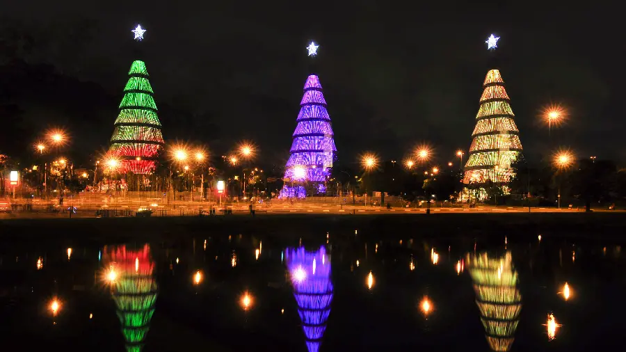 Three-color image of three beautiful and new buildings and their reflection in clear water at night