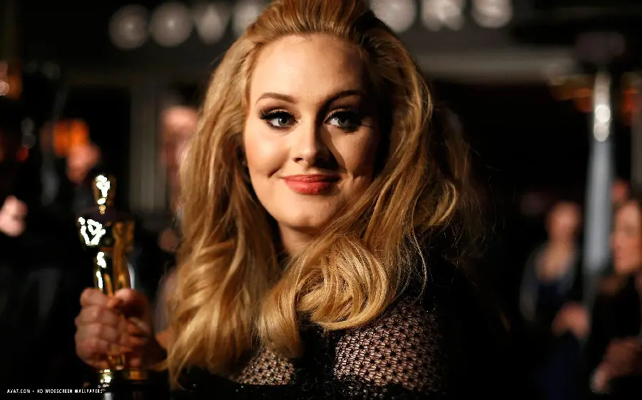 Specially spectacular Telegram profile photo of the British singer Adele with beautiful hair and an award in her hand in full quality
