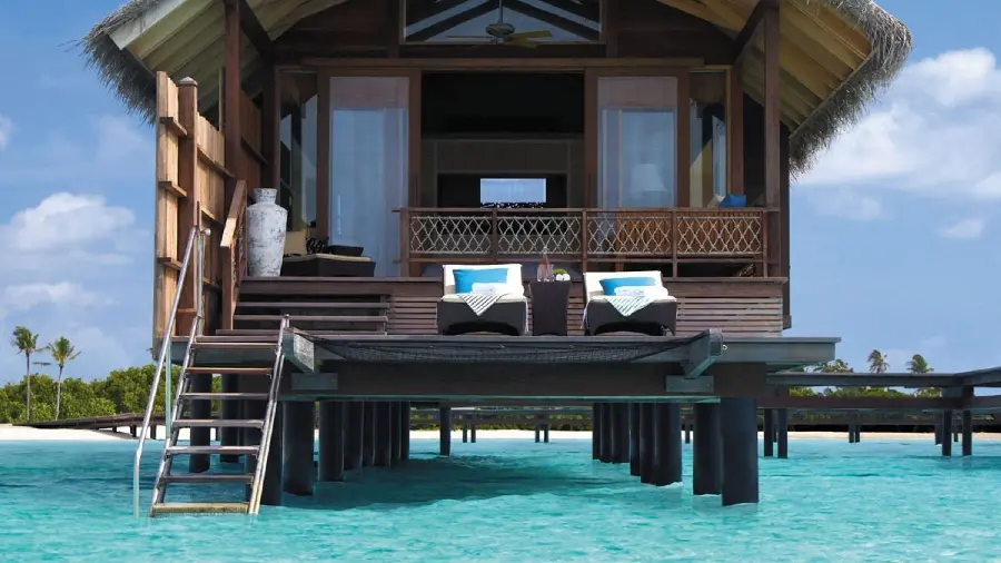 Download clean and neat stock photo of a sunny beach house villa in shallow water