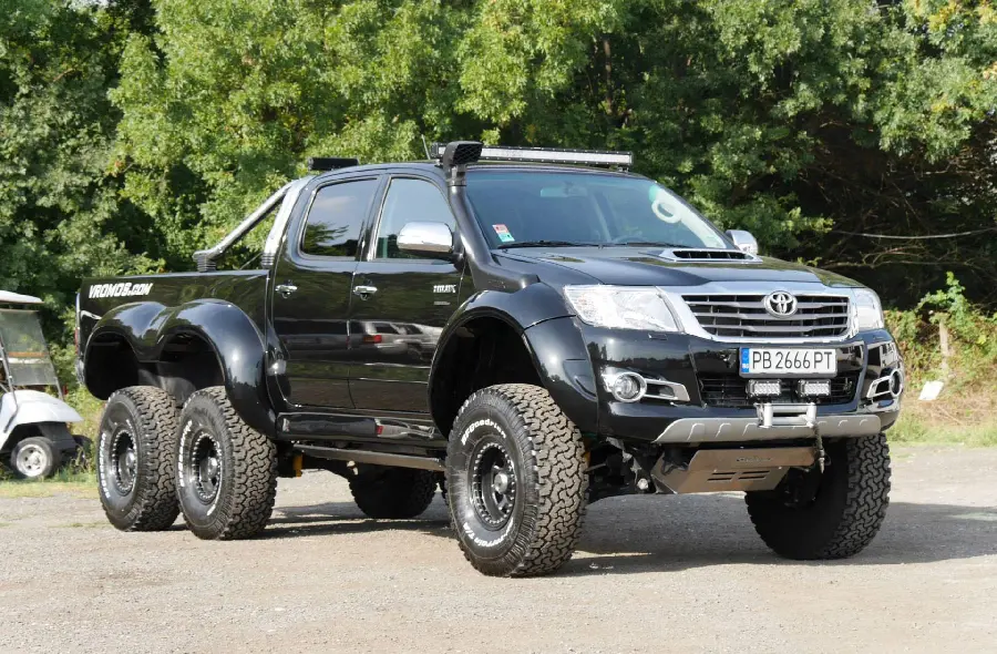 The best background of the amazing Toyota Hilux next to the trees suitable for WhatsApp