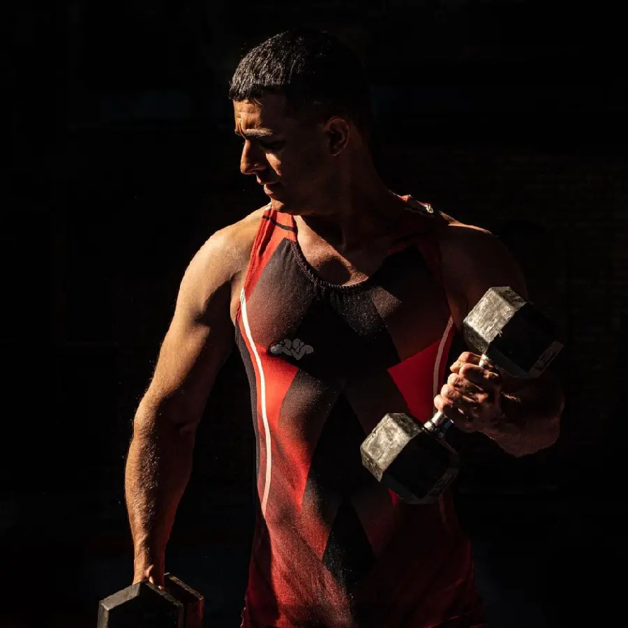 Download a spectacular poster of Javed lifting dumbbells and exercising in a wrestling suit in the series Yaghi