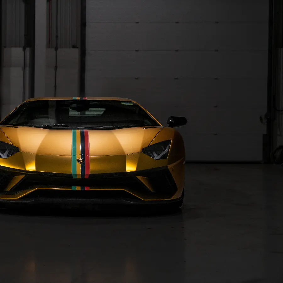 Laptop Background with a Golden Lamborghini Design from the Front on a Black Background