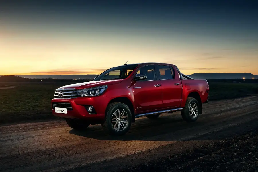 The most beautiful and cute wallpaper of a beautiful red Toyota Hilux at sunset