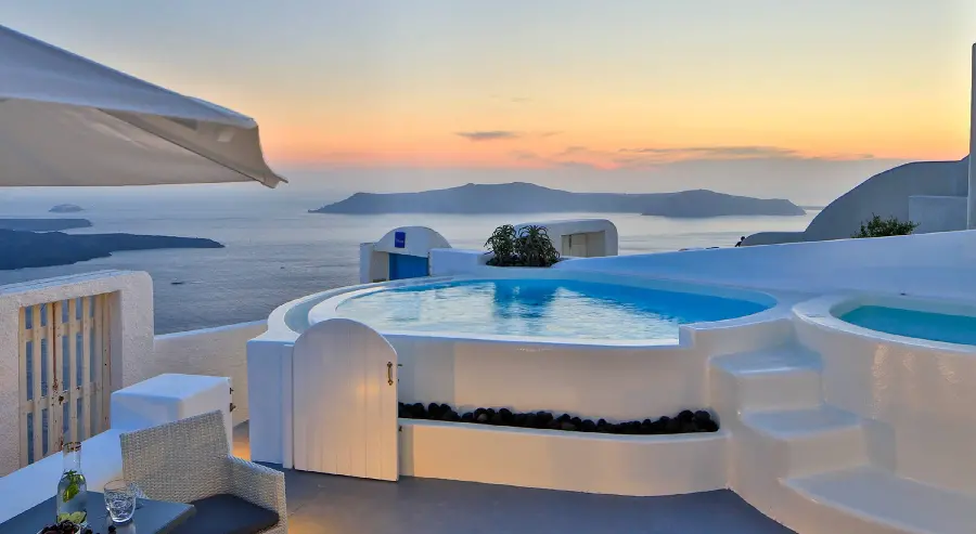 Download tourist stock image of a hotel pool in Santorini