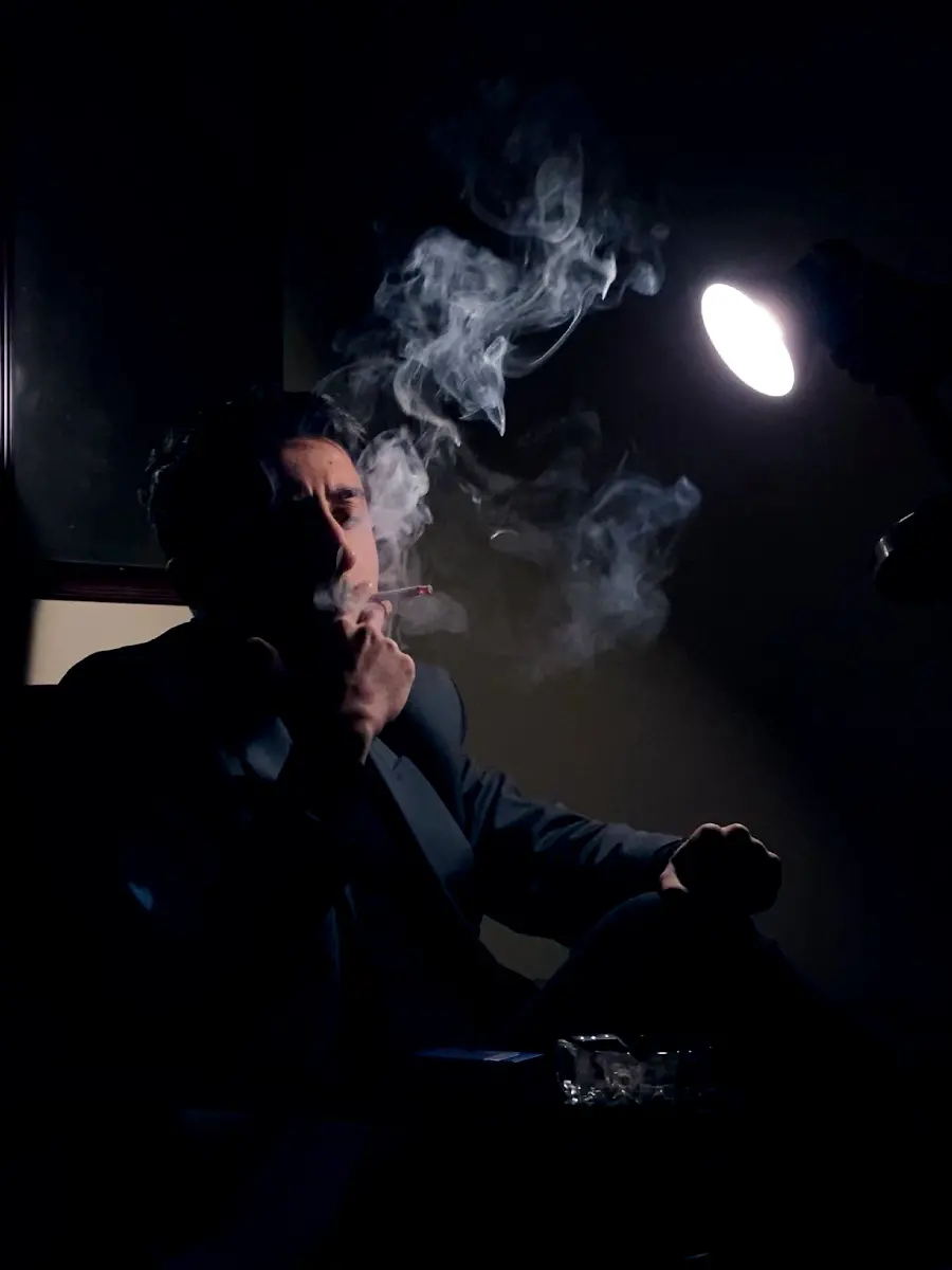 Image of a thoughtful man smoking for making a photo caption 