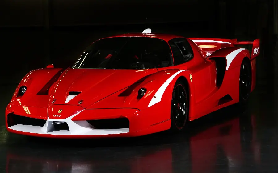 Download a unique image of a red Ferrari Enzo in a black space