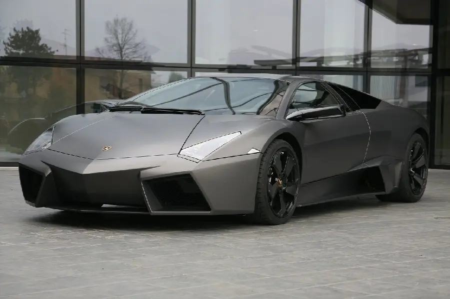 Popular wallpaper of black Lamborghini Runton in front of glass building