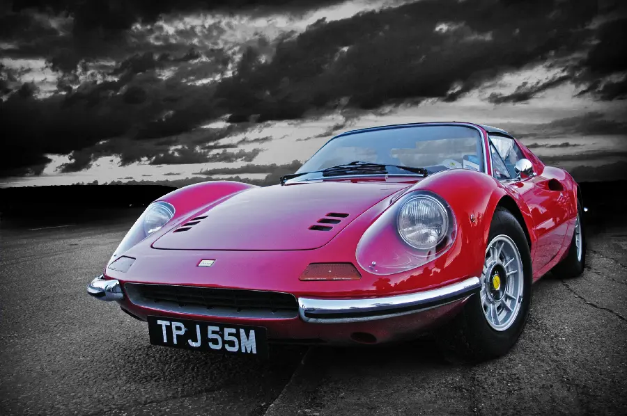 Fantasy black and white photo of an old and classic red Ferrari