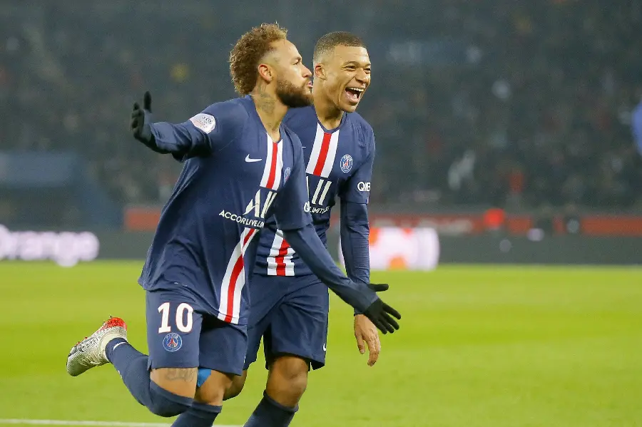 Download stock photo of Neymar and Mbappe standing on the grass with Neymar's arms outstretched