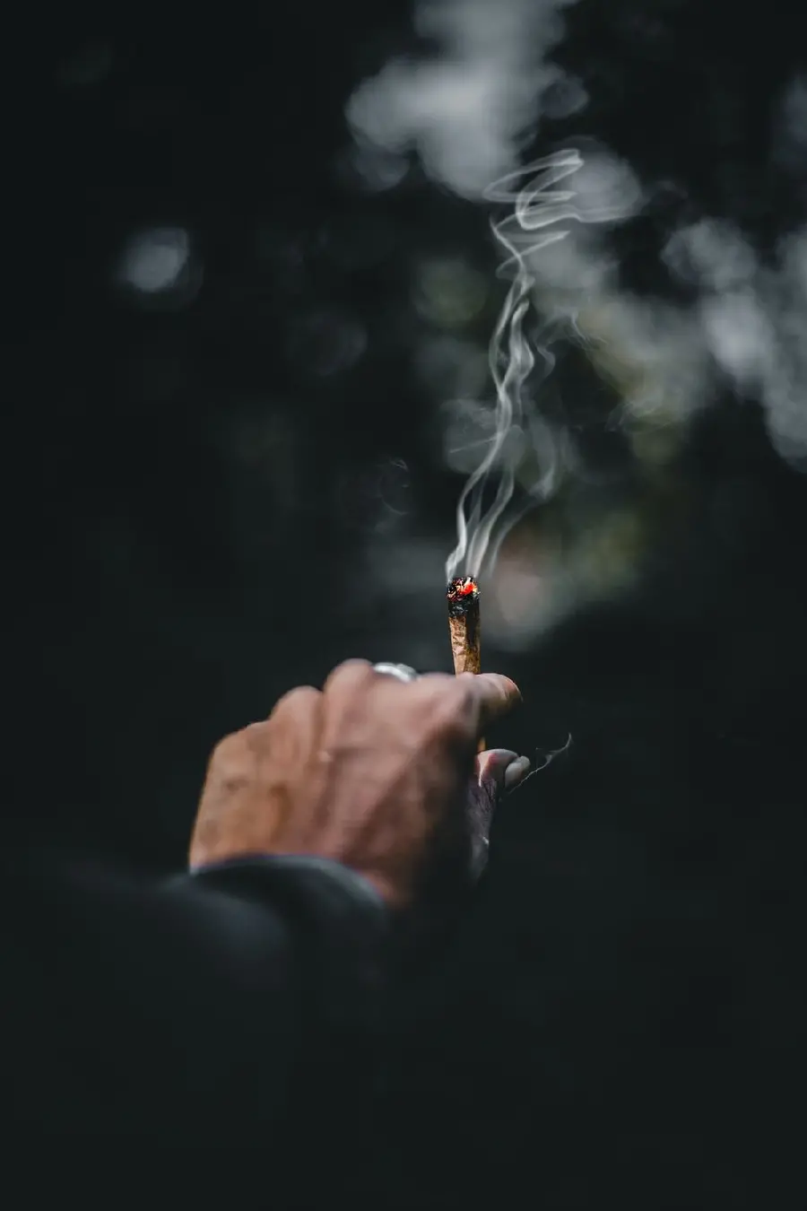 Sad Stock Photo of an Old Man Smoking a Cigarette
