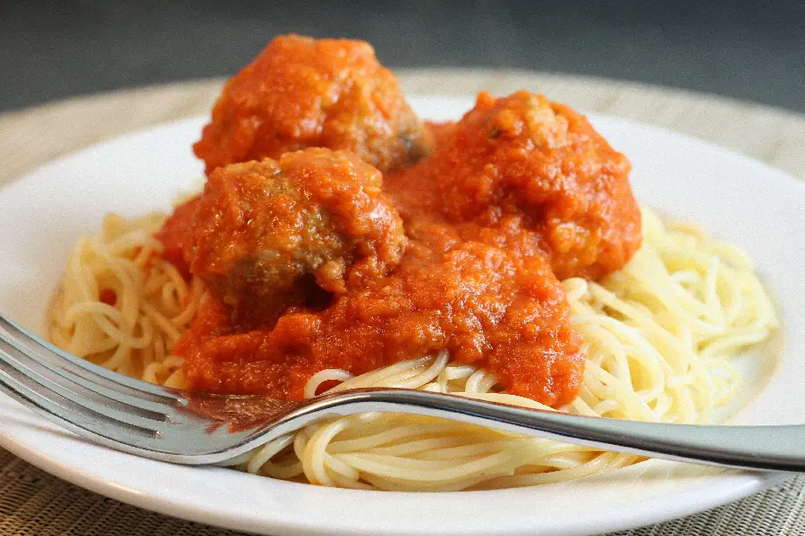 The most amazing high-quality background of a simple pasta dish with a delicious and tasty tomato sauce and dumplings